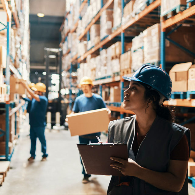 Woman working supply chain management role in a warehouse
