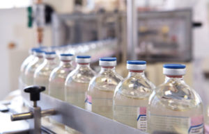 medical vaccine bottles on a belt during the manufacturing process of supply chain