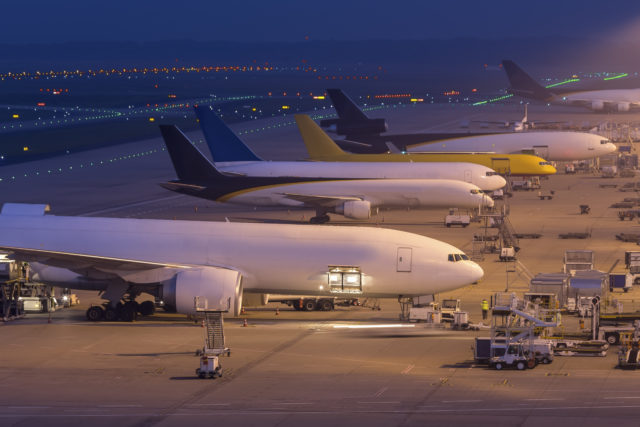 6 planes on a runway waiting to take off