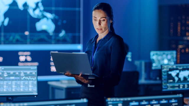 business woman leader standing with laptop