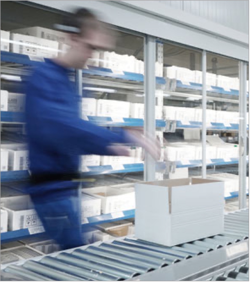 Man putting product in a box on a factory line